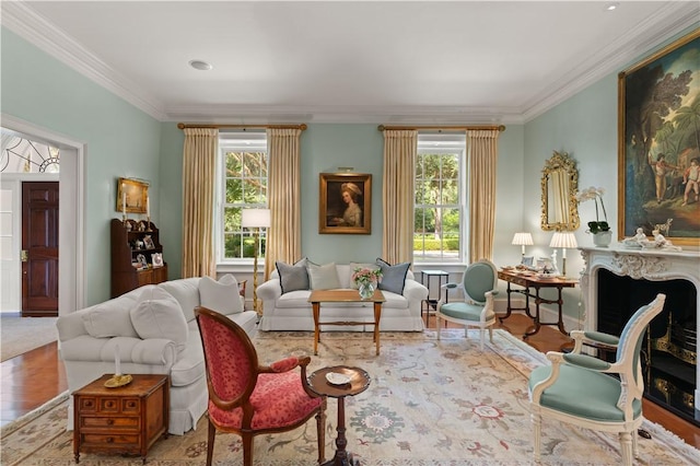 living area featuring light wood-type flooring and ornamental molding