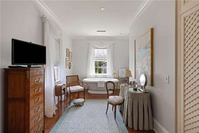 living area featuring light wood-type flooring and ornamental molding