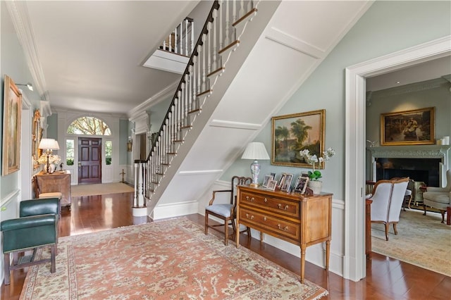 entrance foyer featuring wood-type flooring and ornamental molding