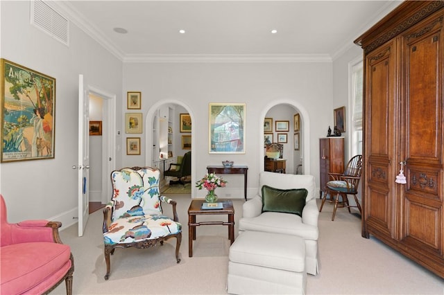 sitting room with light carpet and ornamental molding