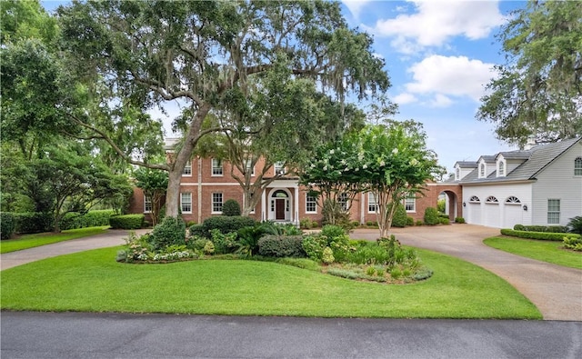 view of front of home with a front yard and a garage