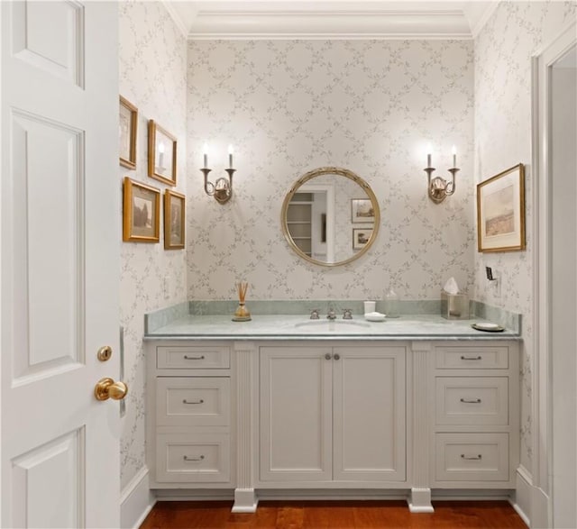 bathroom with wood-type flooring, vanity, and ornamental molding