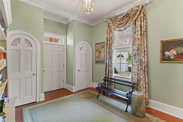 foyer entrance with hardwood / wood-style floors and ornamental molding