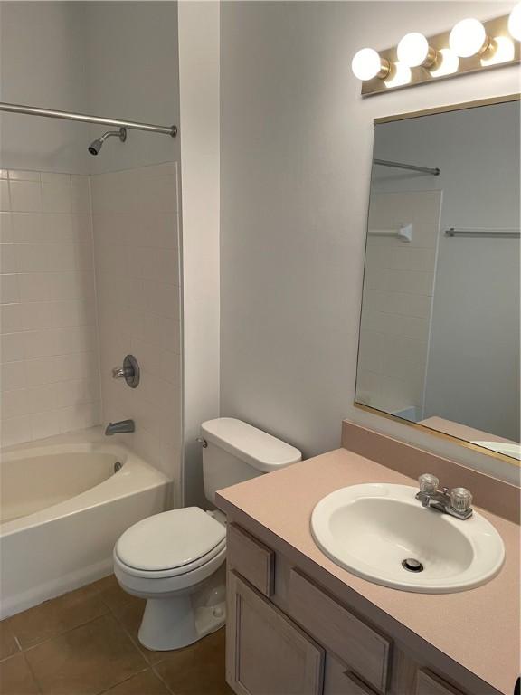 full bathroom with tile patterned flooring, vanity, toilet, and tiled shower / bath