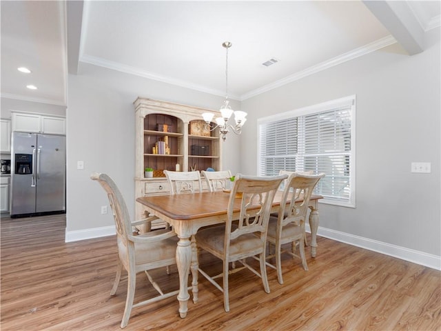 dining space with crown molding, light hardwood / wood-style flooring, and a notable chandelier