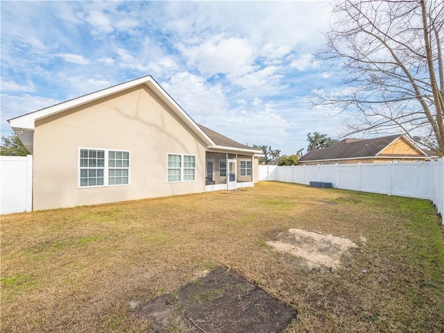 rear view of property with a lawn