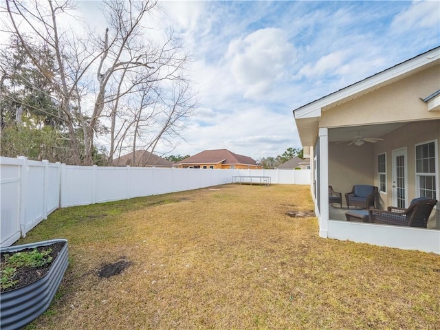 view of yard with ceiling fan and a sunroom