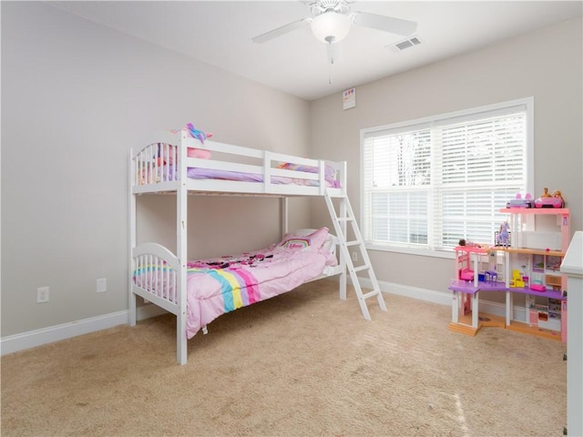 bedroom with ceiling fan and light carpet