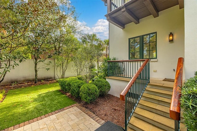 doorway to property featuring a lawn