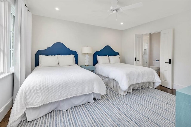 bedroom with ceiling fan, ensuite bathroom, and wood-type flooring