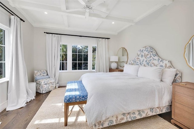 bedroom with beam ceiling, dark hardwood / wood-style floors, multiple windows, and ceiling fan