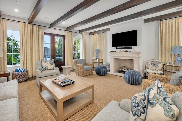 living room with beam ceiling and light carpet