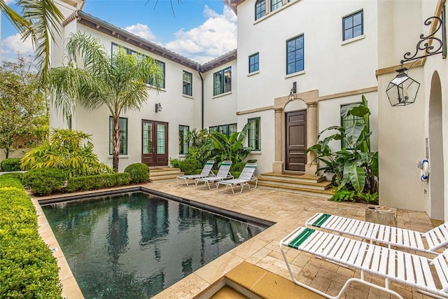 rear view of house featuring french doors and a patio