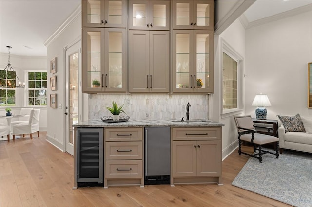 bar featuring beverage cooler, ornamental molding, backsplash, and a sink