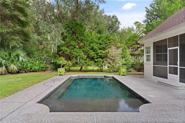 outdoor pool with a yard and a patio