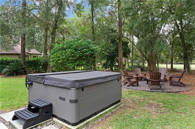 view of yard featuring an outdoor fire pit and a hot tub