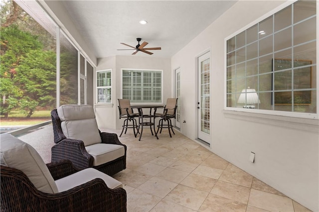 sunroom / solarium with a ceiling fan