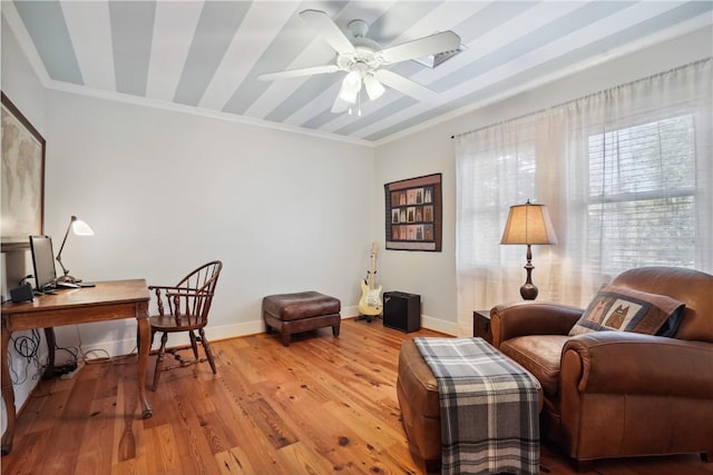 living area featuring ornamental molding, ceiling fan, and light hardwood / wood-style floors