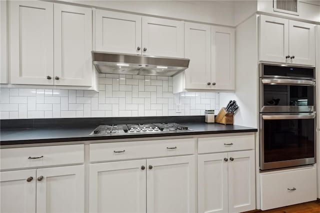 kitchen with backsplash, stainless steel appliances, and white cabinets