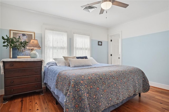 bedroom featuring ornamental molding, dark hardwood / wood-style floors, and ceiling fan