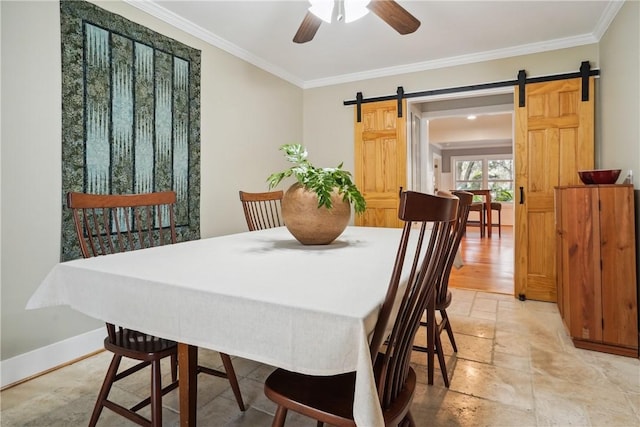 dining space with crown molding, a barn door, and ceiling fan