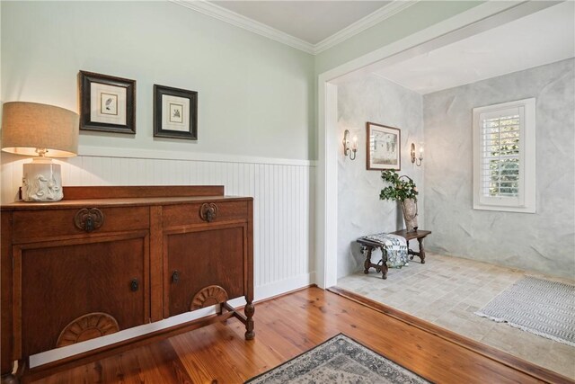 living room featuring ornate columns, ceiling fan, crown molding, light wood-type flooring, and french doors