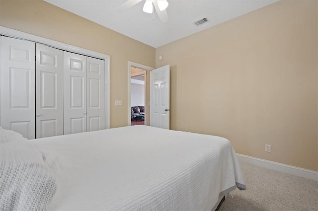 bedroom with ceiling fan, a closet, and carpet floors