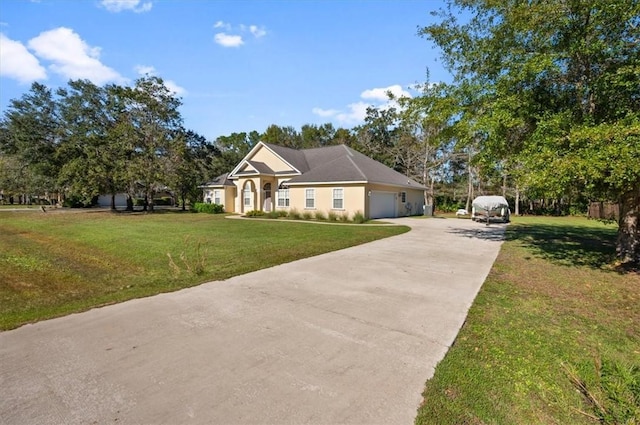 view of front of property with a front lawn and a garage