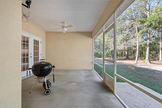 unfurnished sunroom featuring french doors and ceiling fan