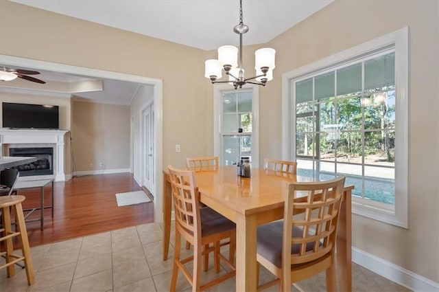 dining room featuring ceiling fan with notable chandelier, light hardwood / wood-style floors, and ornamental molding