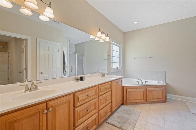 bathroom with plus walk in shower, tile patterned flooring, and vanity