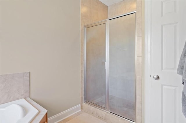 bathroom featuring separate shower and tub