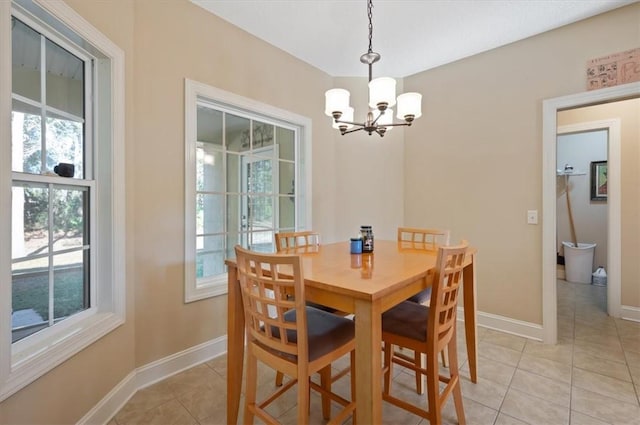 tiled dining space featuring an inviting chandelier