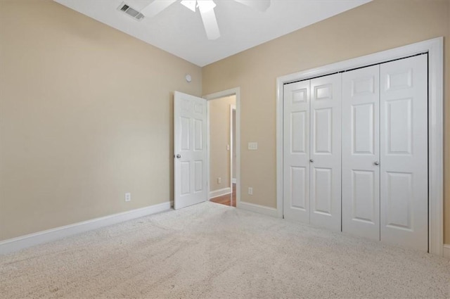 unfurnished bedroom with carpet floors, a closet, and ceiling fan