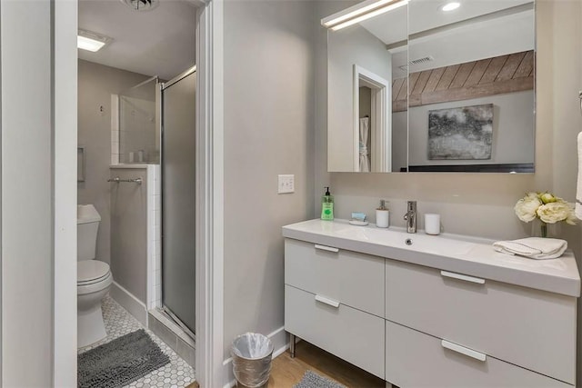 bathroom featuring vanity, an enclosed shower, and toilet