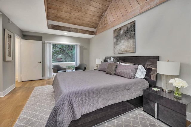 bedroom featuring vaulted ceiling, wooden ceiling, and light hardwood / wood-style floors