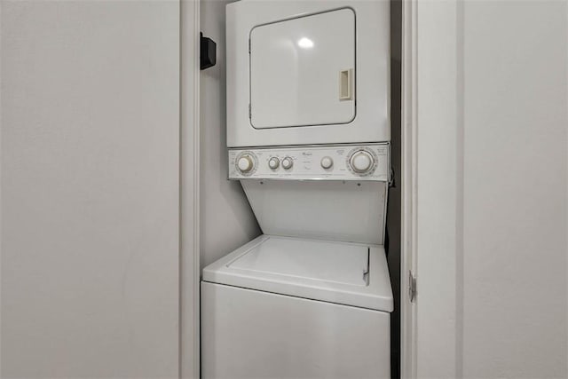 laundry area with stacked washer and clothes dryer