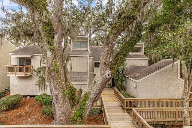 back of property featuring a balcony