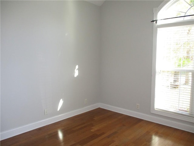 empty room featuring dark wood-type flooring