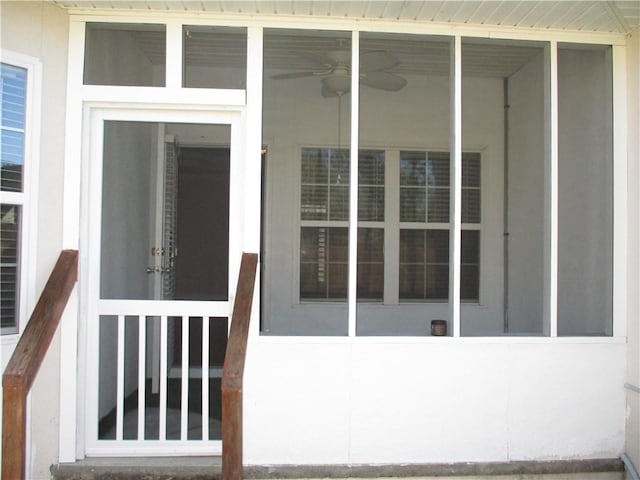 entrance to property featuring ceiling fan