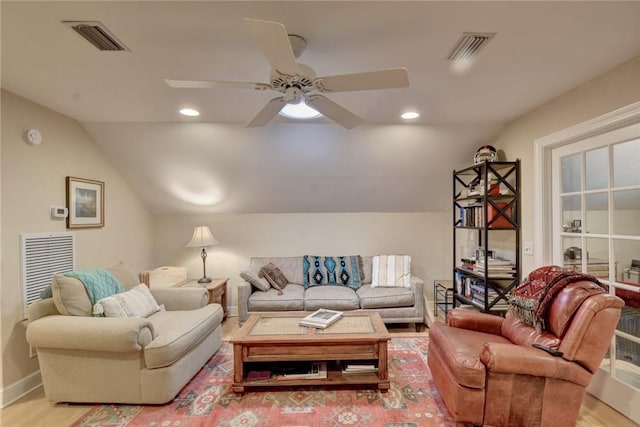 living room featuring ceiling fan, light hardwood / wood-style flooring, and lofted ceiling