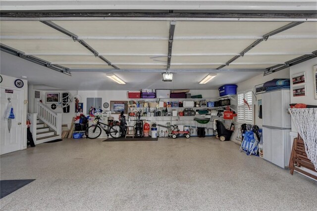 garage with a workshop area and a garage door opener