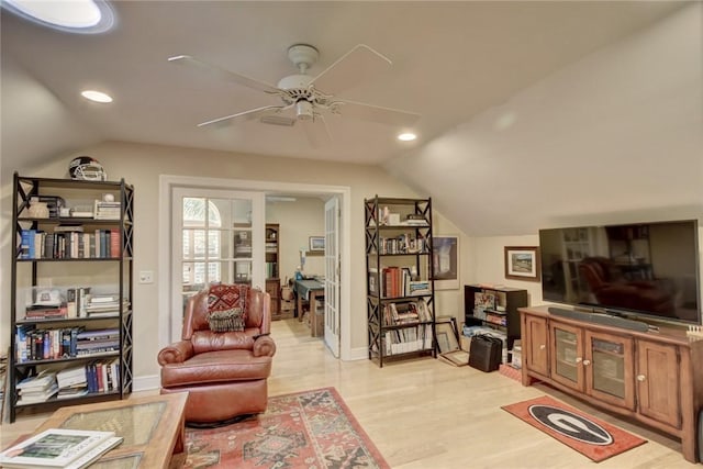 living area with light wood-type flooring, vaulted ceiling, and ceiling fan