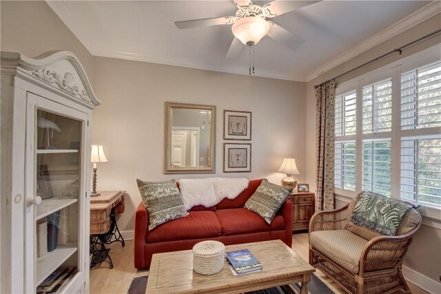 living room with ceiling fan, light hardwood / wood-style floors, and crown molding