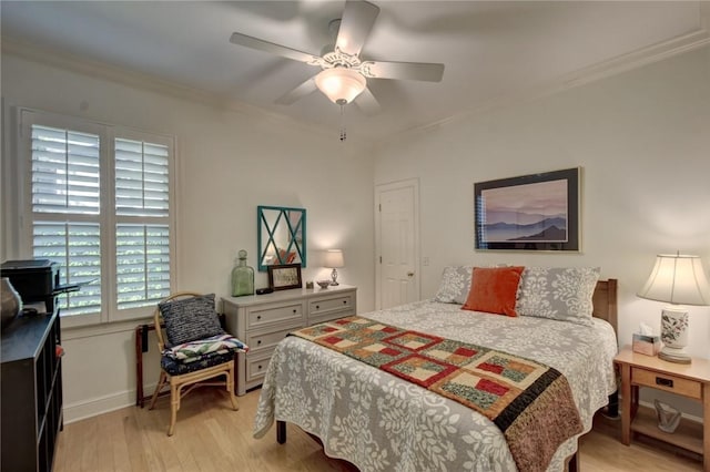 bedroom with ceiling fan, light wood-type flooring, and crown molding