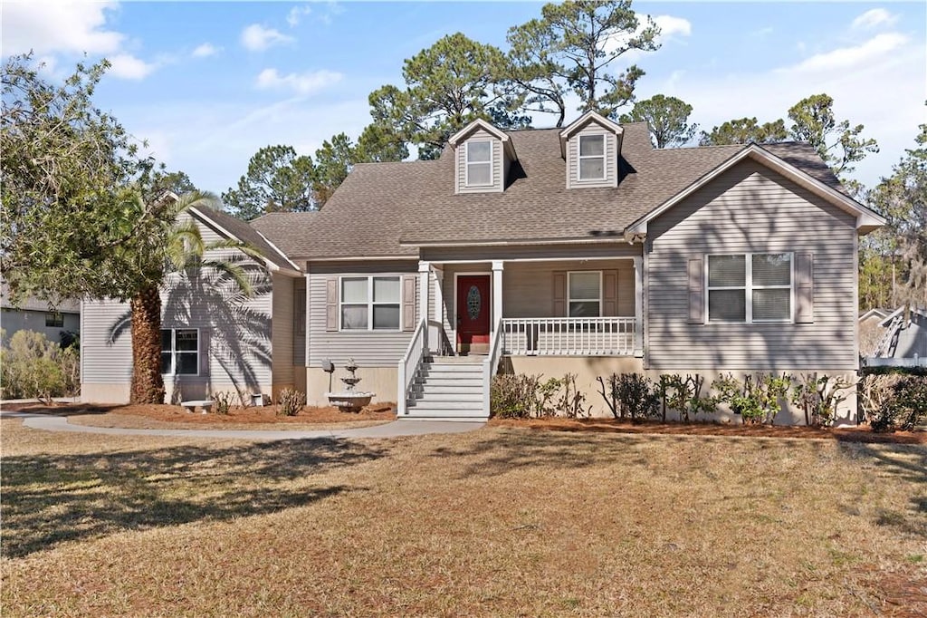 cape cod-style house with covered porch and a front lawn