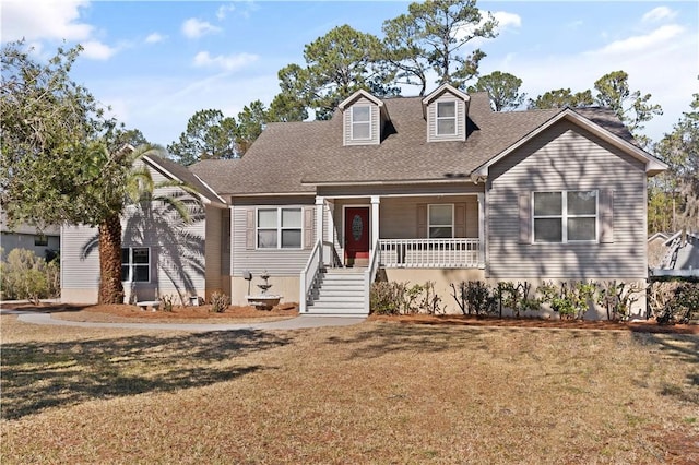 cape cod-style house with covered porch and a front lawn