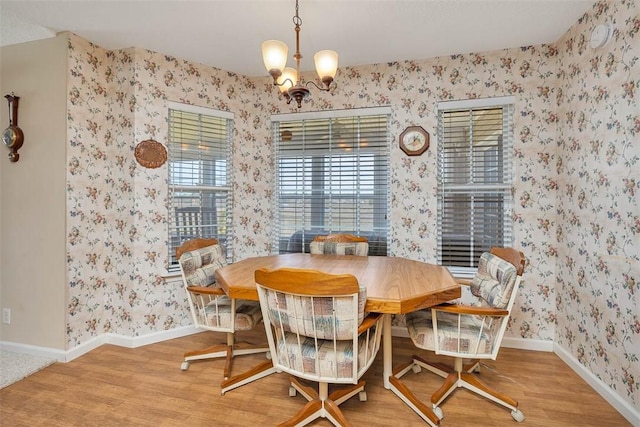 1056 Fiddler Trce, Townsend, GA 31331 - dining space featuring wallpapered walls, a chandelier, and wood finished floors