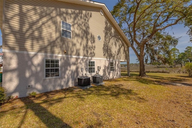 1056 Fiddler Trce, Townsend, GA 31331 - view of side of home with stucco siding and a yard