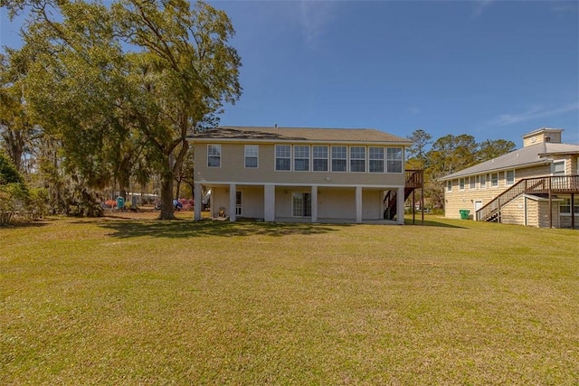 1056 Fiddler Trce, Townsend, GA 31331 - back of house featuring stairway, a yard, and a wooden deck